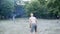 Slow motion of young slim athletic man with bare torso catching and throwing frisbee.