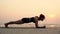 Slow motion of young woman practice yoga Plank or Phalakasana Pose on the beach