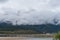 Slow moving clouds over the pine forest covered mountains