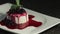 A slow moving footage of a panna cota cake on a rotating table