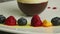 Slow panorama on blueberry, raspberry, and orange served in row