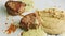 Slow panorama closeup of two grilled meat pieces with puree and sauce