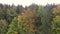 Slow rising footage of aerial photography with drone in Bavarian forest over treetop forest with passing fog mist near Grafenau, G