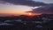 Slow rising footage of a sunset in winter with snow and ice with view from Rusel towards Schaufling and Landshut, Germany