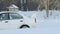SLOW: Sport car turns on a winter ice road - side view