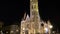 Slow tilt shot down the main spire of Matthias Church, Fisherman`s Bastion, Budapest, Hungary illuminated at night