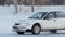 SLOW: White sport car turns on a winter ice road
