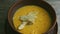 Slow zoom in at cheese cream soup decorated with mushrooms and dried bread