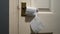 SLOW ZOOM IN on an empty toilet roll hanging from a brass door handle