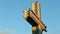 Slowly panorama closeup at large metal cross against blue sky at sunset