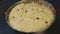 Slowly panorama closeup on soft yeast dough with raisins in deep metal bowl