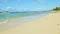 Slowly panorama on empty shore of blue ocean with waves and golden sandy beach