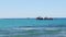 Slowly panorama at seascape with white waves and large black ship