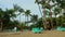 slowly round panorama of tropical sandy beach with empty resort sunbeds