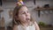 Slowmo, close-up portrait of cheerful Caucasian brunette girl with face dirty with sweets chewing cake. Joyful little