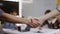 Slowmo close-up of unrecognizable business partners shaking hands after making successful deal