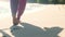 slowmo closeup of feet from behind walking on the beach