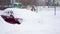 Slowmo woman cleans the car from snow. Winter is in the city and cars are covered with snowdrifts. A lot of