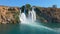 Slowmotion aerial video of the Lower Duden Waterfall in the city of Antalya. The drone slowly rotates around the