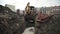 Slowmotion bulldozer excavator dump dirt in to sewer ditch at building site