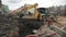 Slowmotion bulldozer excavator dump soil in to sewer trench at building site