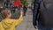 Slowmotion of a little boy holding a small Chinese flag walk the Quinmen Main Street Mall. The Forbidden City in the