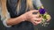 Slowmotion shot of hands of professional blonde female floral artist arranging beautiful bouquet at flower shop