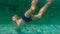 Slowmotion shot of little boy diving and splashing in a pool