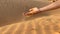 Slowmotion shot of a sand that pours from a man's hand