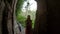 Slowmotion shot of a young family visiting the Gunung Kawi Sebatu Temple. 11th century temple and burial complex in