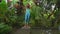 Slowmotion shot of a young woman failing to step on a Sadhu board or a nail board in a tropical surrounding