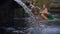 Slowmotion shot of a young woman visiting the holly springs in Indonesia. Tirta Empul holy water springs on the Bali