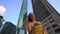 Slowmotion shot of a young woman that waves Malaysian flag with skyscrapers at a background. Travel to Malaysia concept