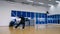 Slowmotion: skillful man attacks the invisible opponent in the air in the gym