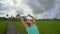 Slowmotion steadicam shot of a young woman practicing yoga on a beautiful rice field