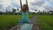 Slowmotion steadicam shot of a young woman with yoga math walking through a beautiful rice field