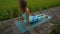 Slowmotion steadicam shot of a young woman with yoga math walking through a beautiful rice field