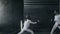 Slowmotion of Two fencers man and woman have fencing training indoors