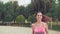 Slowmotion video of fit woman running in the park . sport training