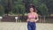 Slowmotion video of fit woman running in the park . sport training