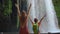 Slowmotion video. A woman and her son are portrayed as tourists visiting the breathtaking Upper Duden waterfall in the