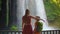 Slowmotion video. A woman and her son are portrayed as tourists visiting the breathtaking Upper Duden waterfall in the