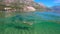 Slowmotion. Woman snorkeling at the sea. Half view of ocean and mountains.