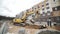 Slowmotion yellow excavator digging soil in ditch at building site