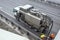 Sludge washer truck suction machine and workers specialists at work on the side of the highway to clean underground infrastructure