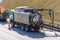 Sludge washer truck suction machine and workers specialists at work on the side of the highway to clean underground infrastructure