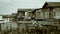 Slum wooden houses on the riverbank of Mahakam, Samarinda, Borneo, Indonesia. monochrome