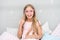 Slumber party photo booth props. Kid girl cheerful posing with pink eyeglasses party attribute. Prepare photo booth