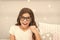 Slumber party photo booth props. Kid girl cheerful posing with vintage black eyeglasses party attribute. Prepare photo