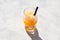 Slushie - drink with natural orange juice. Refreshing summer drink. Spanish granizado or Sweet shaved ice in clear glass, top view